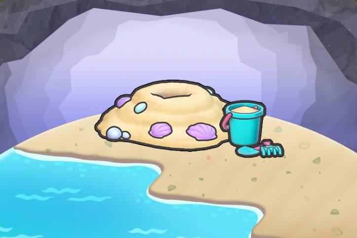 A sand mound near a pail and sand toys in Pokopia