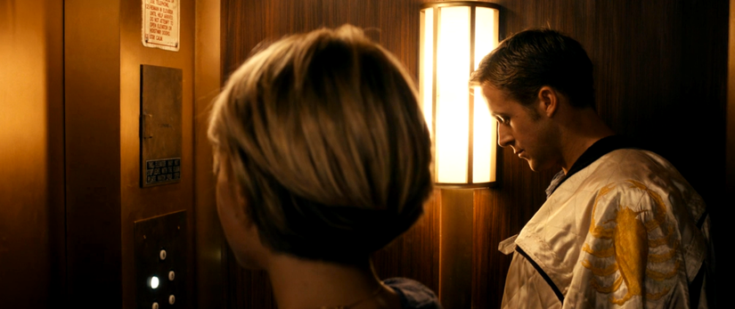 The Driver and Irene share a quiet moment in the elevator in Drive