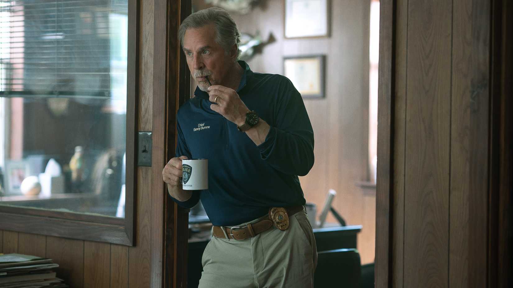 Police Chief Sandy Burnne (Don Johnson) leans against a door in Rebel Ridge
