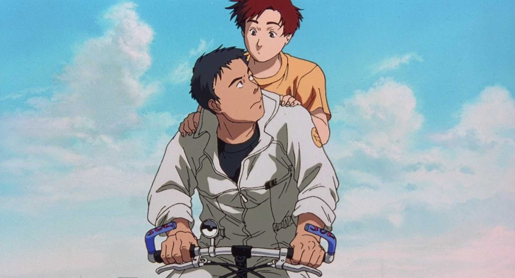 Two young men ride a bicycle together in Patlabor 2
