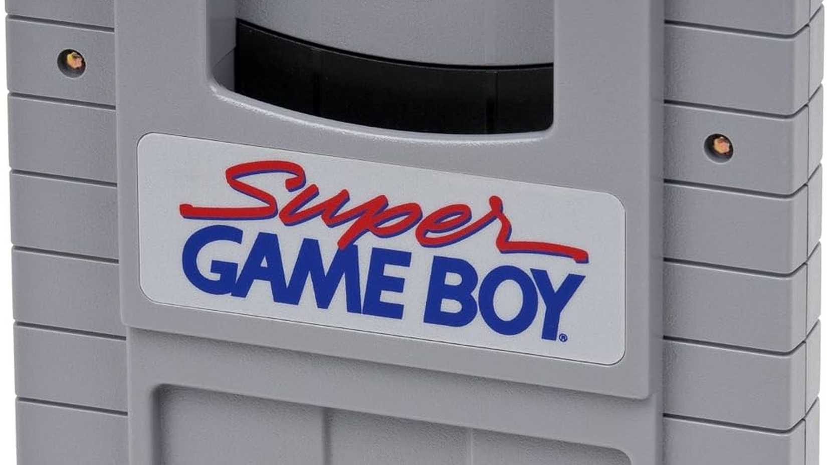 A closeup of the Super Game Boy device, showing the front-facing logo and a cartridge slot.