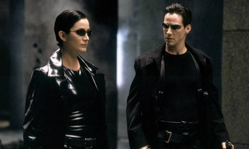 Trinity and Neo walk together in The Matrix