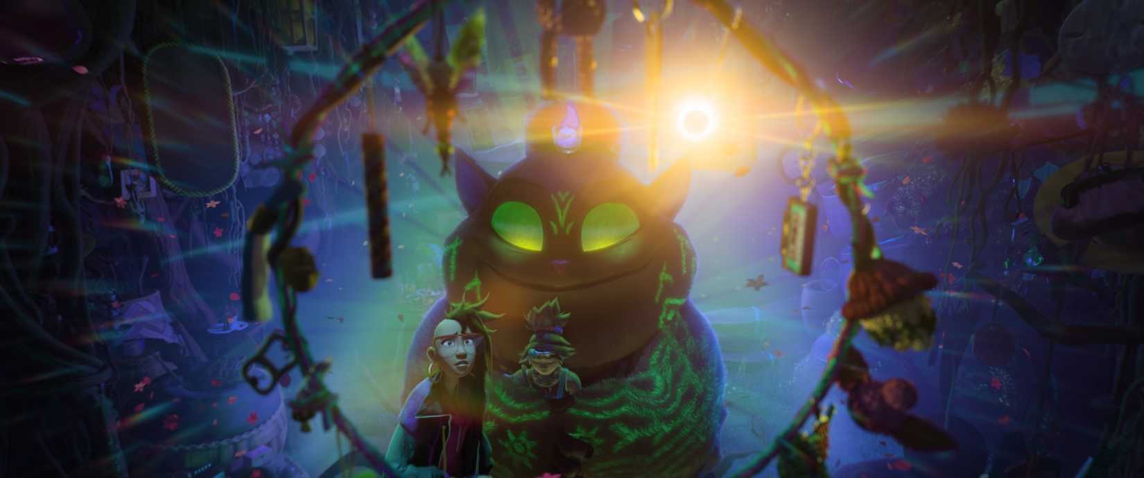 Batiba, a round, catlike demon with glowing green eyes and glowing patterns all over her fur, stands with Filipino teenagers Jo and Raissa in a dark cave in Forgotten Island