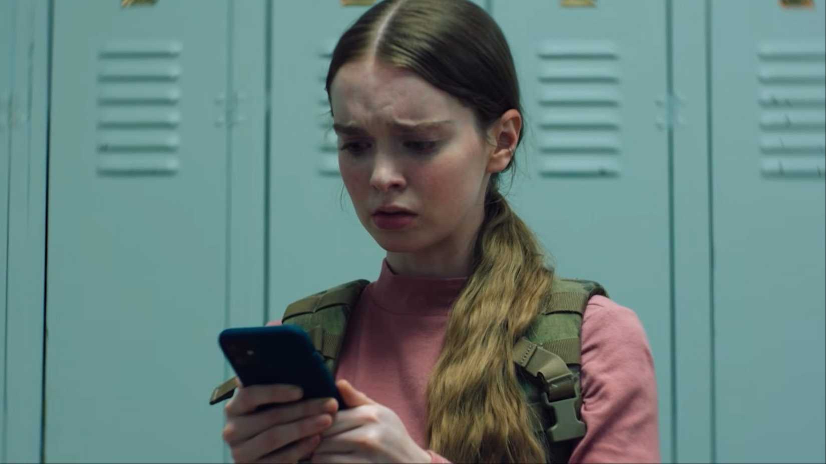 carrie white checks phone looking concerned