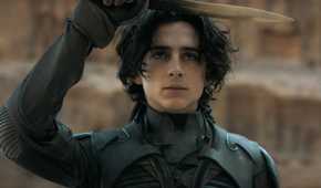 Timothée Chalamet salutes with a crysknife in the film Dune.