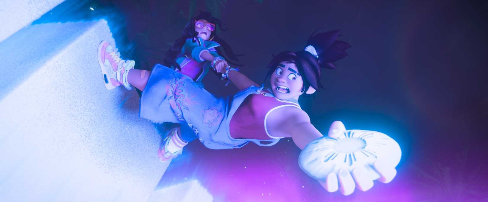 Raissa, a Filipino teenager, clings to her friend Jo, who's standing partway down into an glowing abyss, clutching a glowing rock, in Forgotten Island