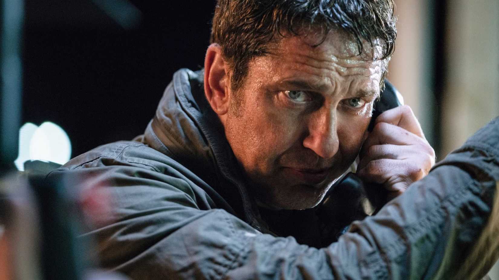 Mike Banning (Gerard Butler) acting paranoid and surly while talking on a pay phone — yes, really! — in Angel Has Fallen