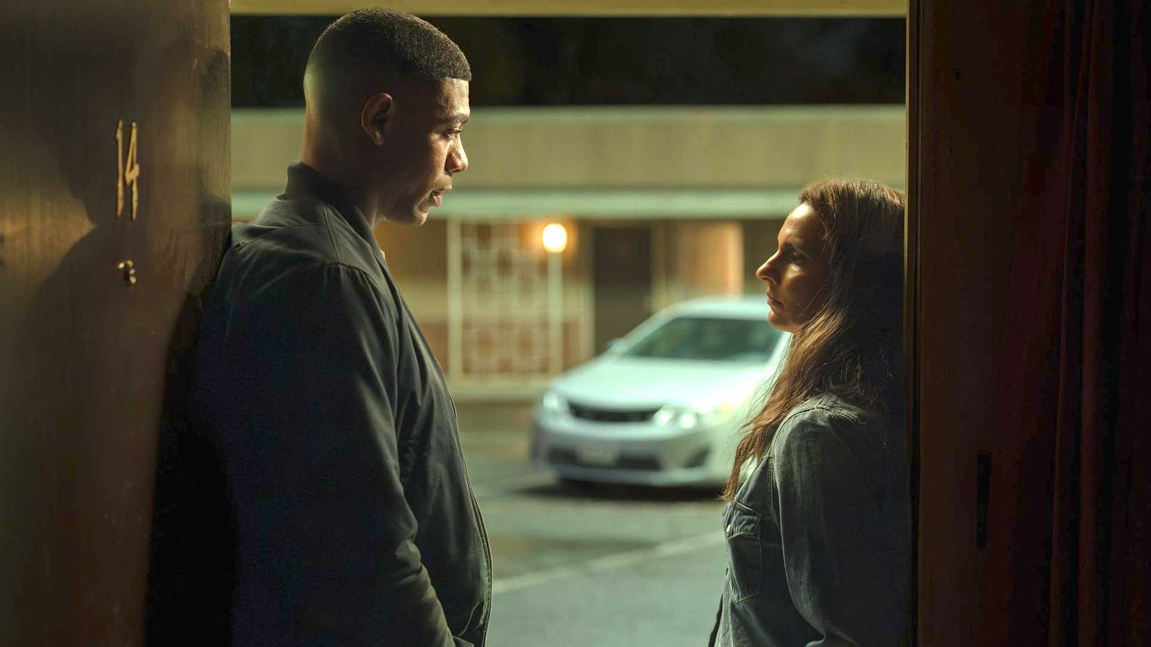 John Stewart (Aaron Pierre) stands in the doorway of a motel speaking to Zoe Macon (Poorna Jagannathan) in Lanterns