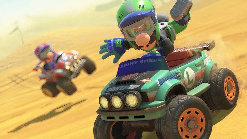 Luigi does a trick in an off-road car with Mario behind