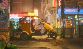 A car parks in front of a bodega in No Law