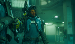 A guy in a mech suit holds a gun in No Law