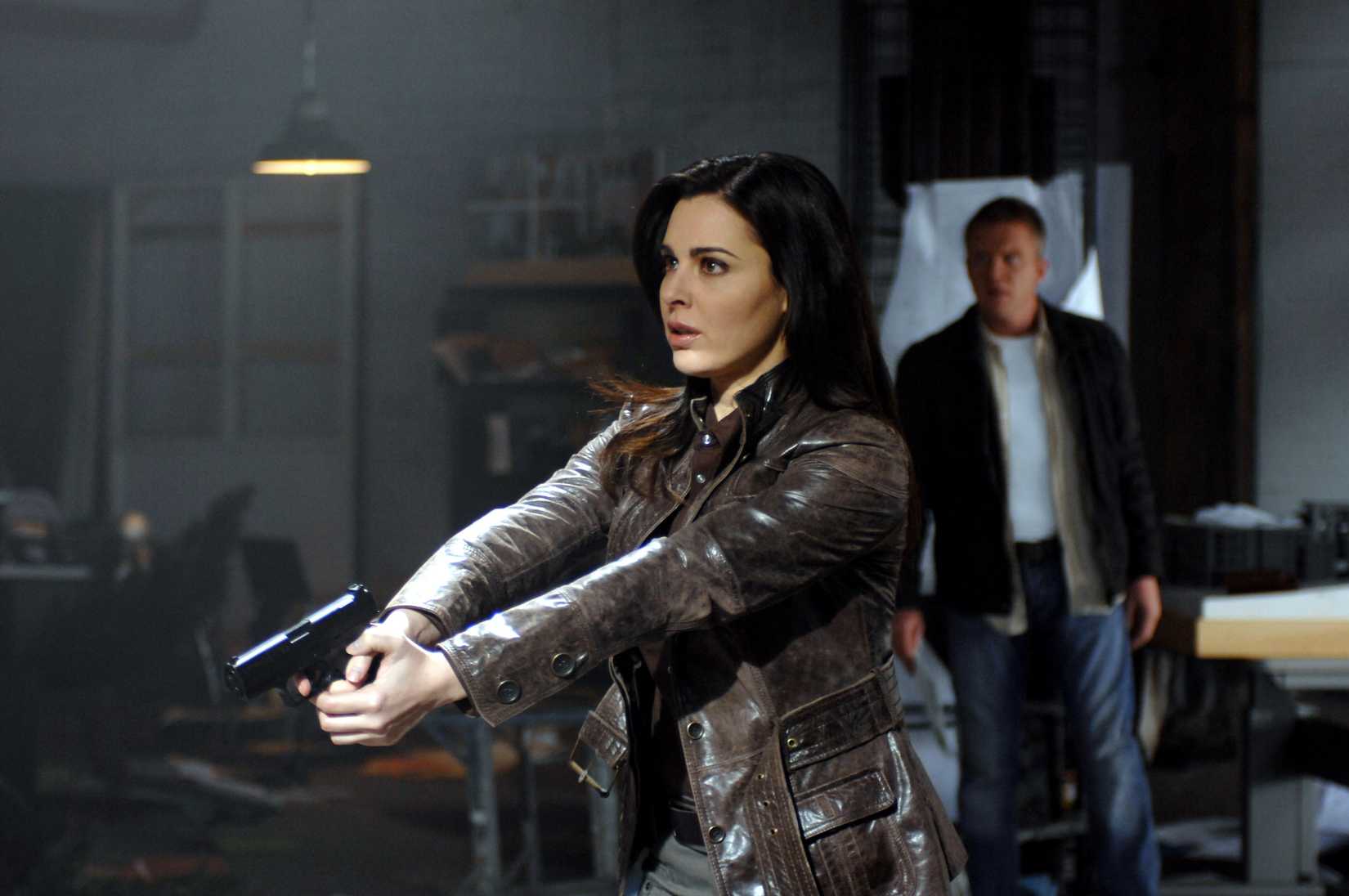 A woman wields a gun in The Dead Zone