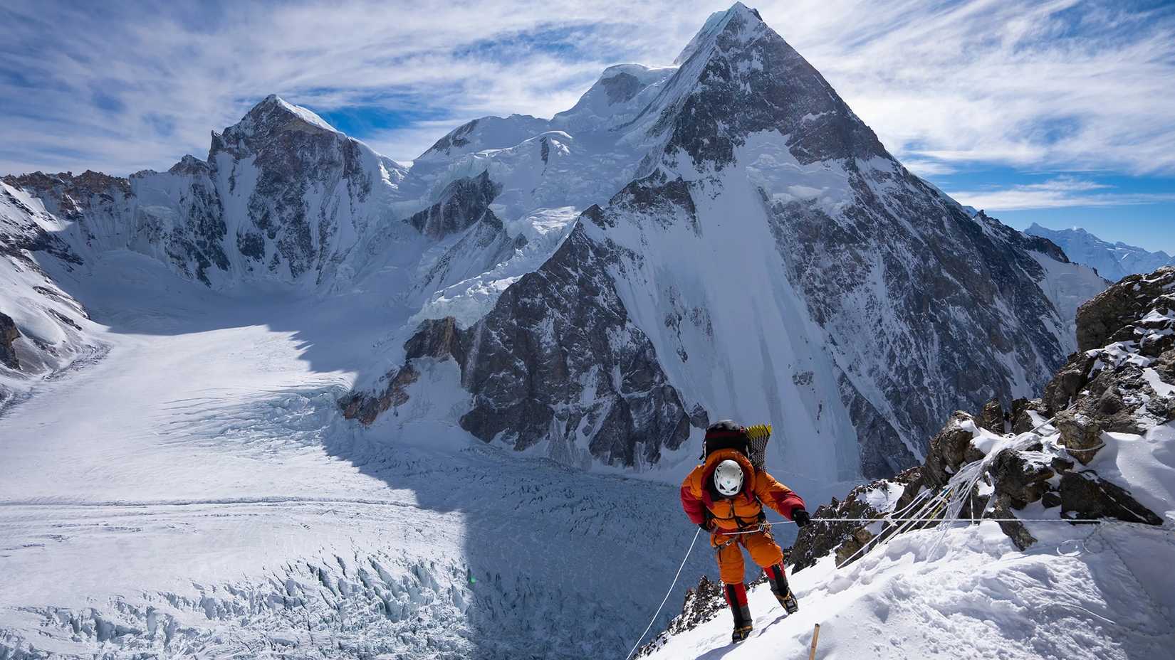 A man climbing a snowy mountain in The Last First: Winter K2