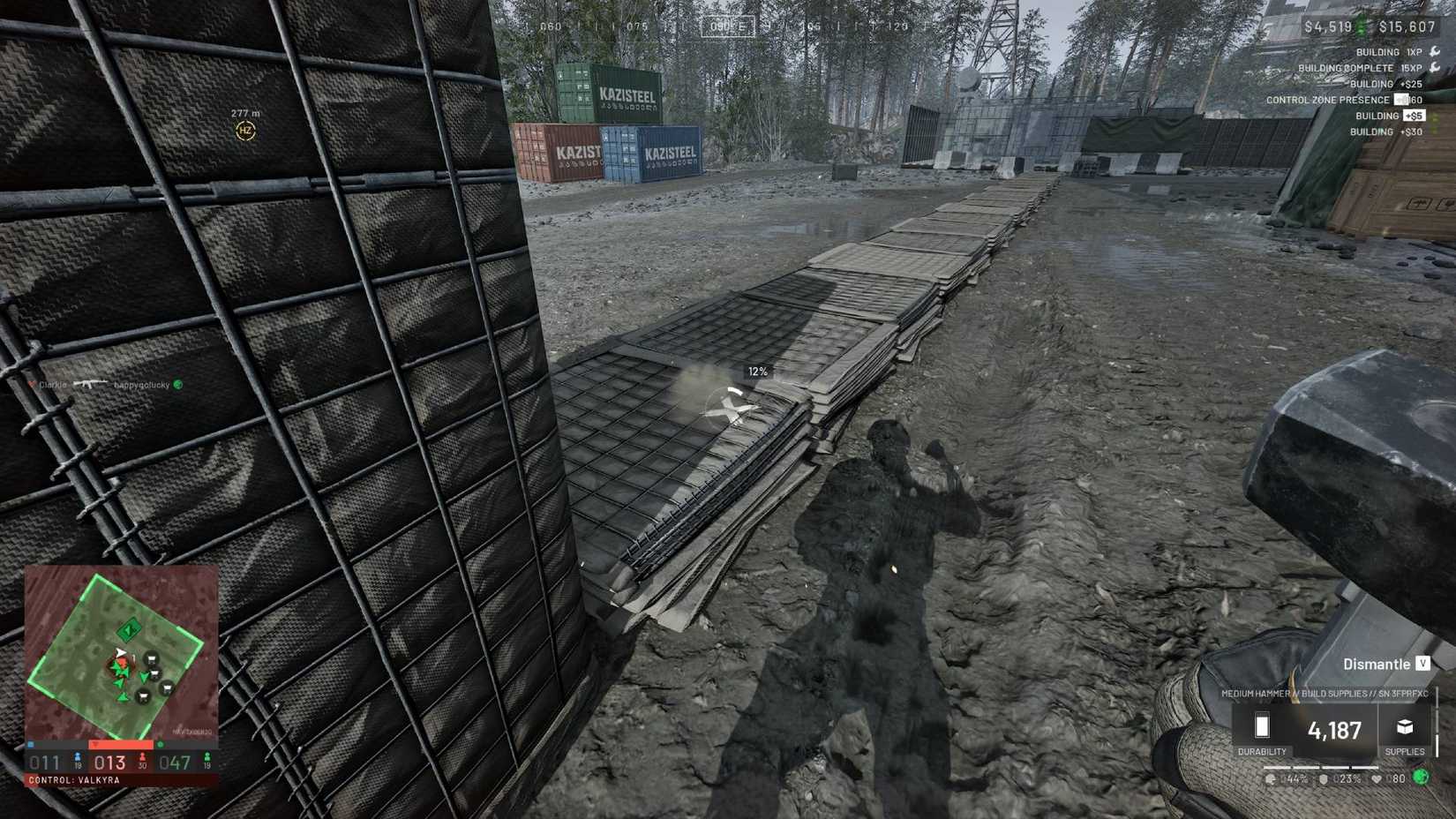 The player using a hammer to build walls of hesco boxes in Wardogs.