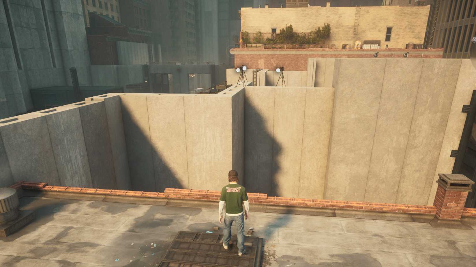 Dylan standing on a rooftop looking at three cameras on a concrete wall in Control Resonant.