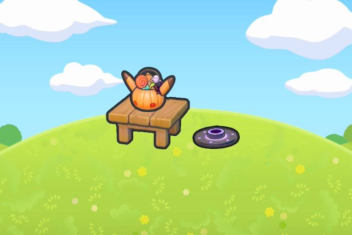 A Pokopia habitat with a bucket of Halloween candy on a table with a smoke machine nearby