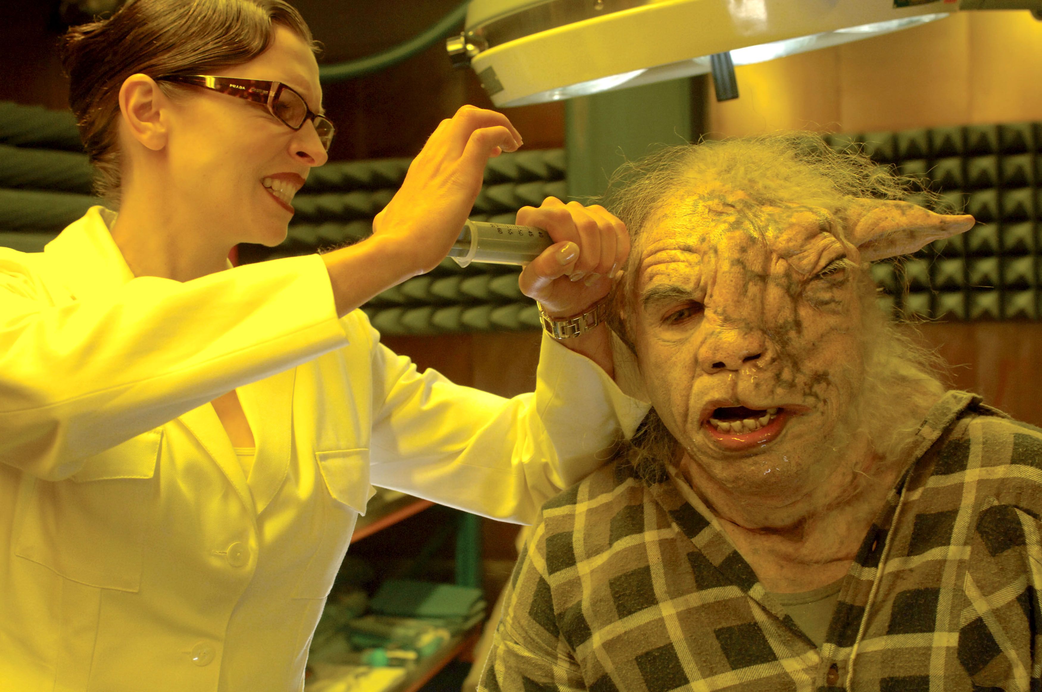 A scientist inserts a tool into the head of a were-sheep.