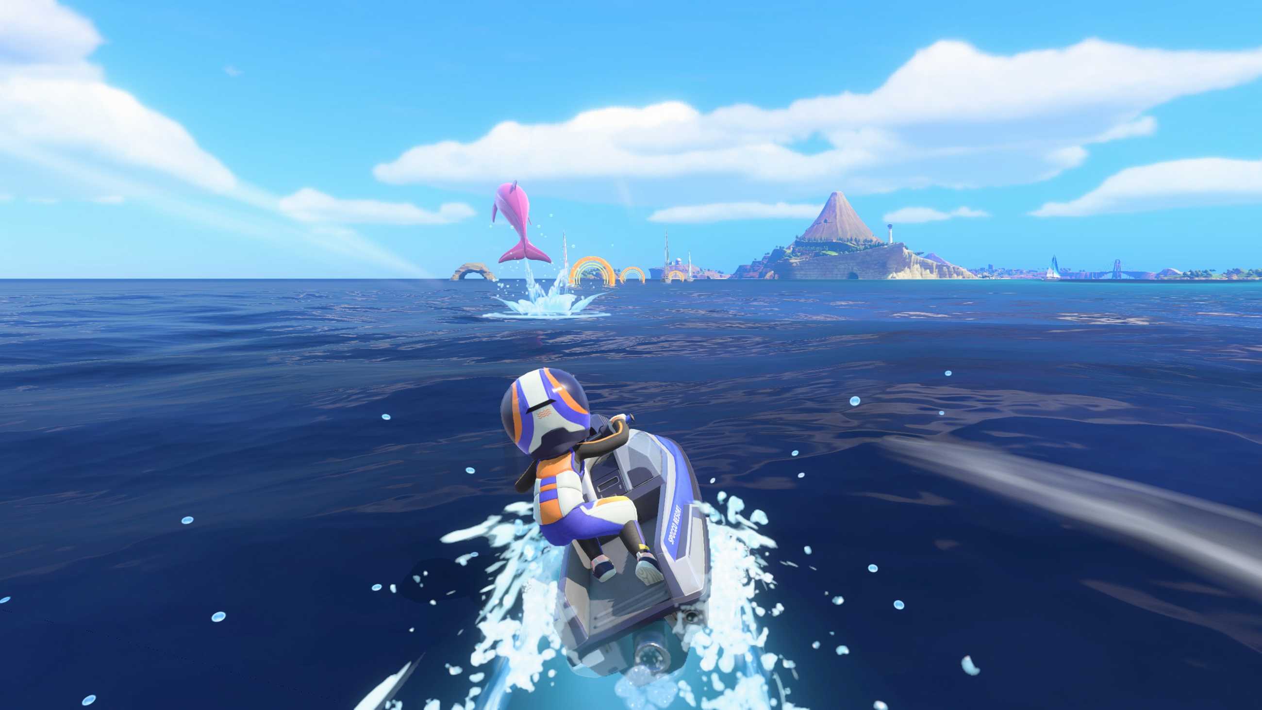 A jet ski rider zooms toward a pink dolphin with an island in the background