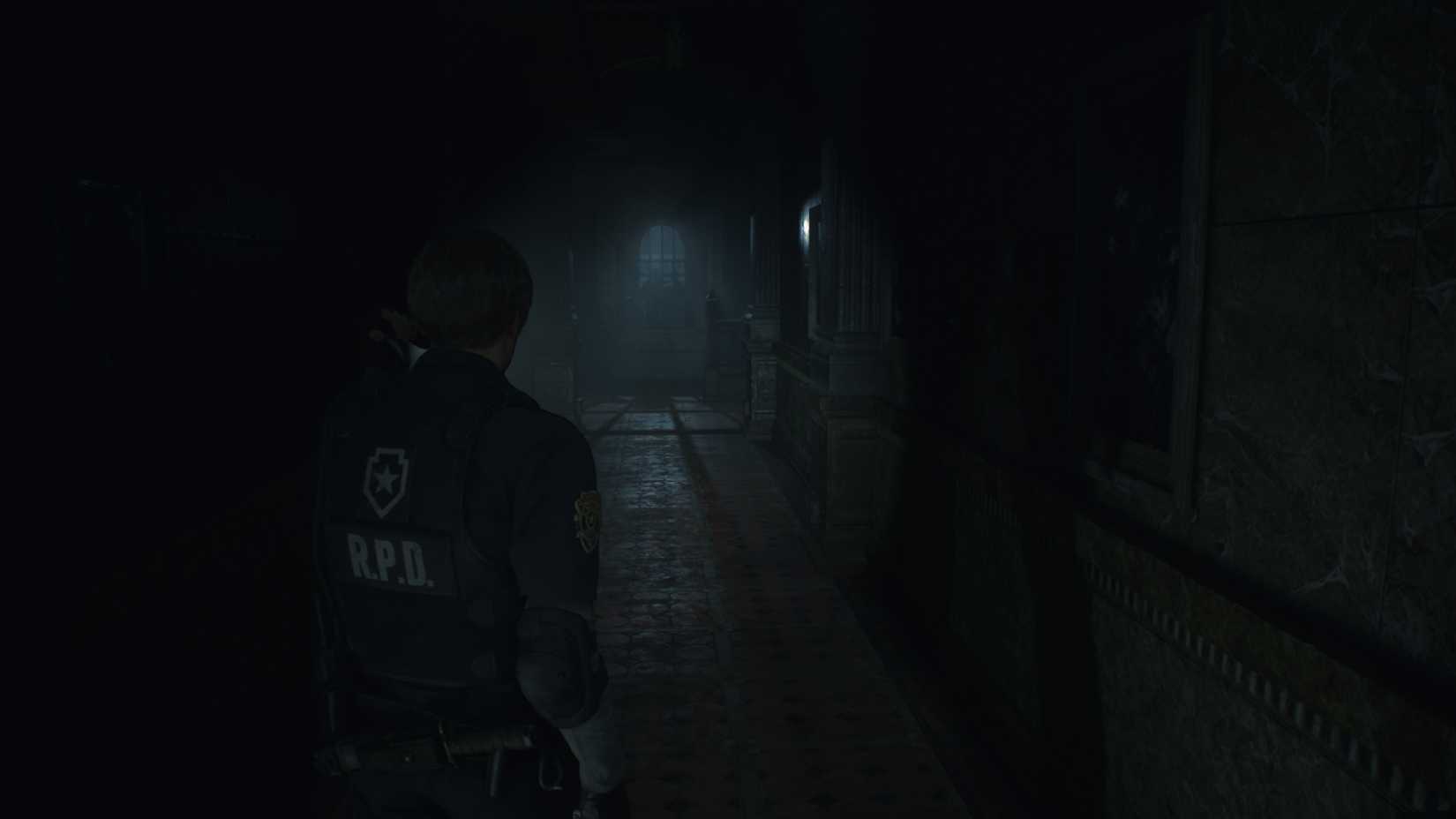 Leon in a dark hallway in Resident Evil 2