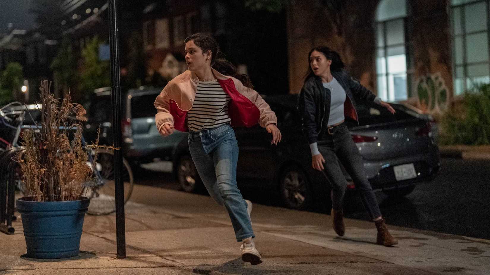 Siblings Tara and Sam Carpenter (Jenna Ortega and Melissa Barrera) flee in panic in a scene from Scream 6.