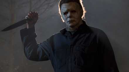 Michael Myers holds a knife menacingly in his white mask in 2018’s Halloween.