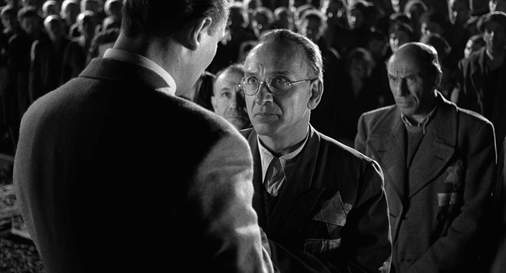Oskar Schindler (Neeson) and Itzhak Stern (Kingsley) face each other.