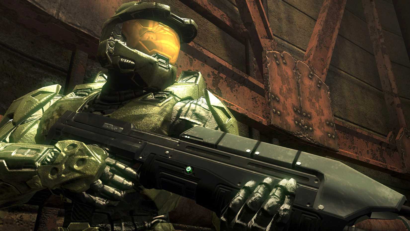 A close up of Master Chief in Halo: Combat Evolved. He is looking to the right and holding a large fun.