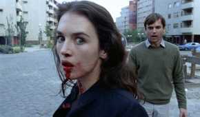 Isabelle Adjani with blood coming out of her mouth, and Sam Neill standing behind her, both looking distressed, in Possession.