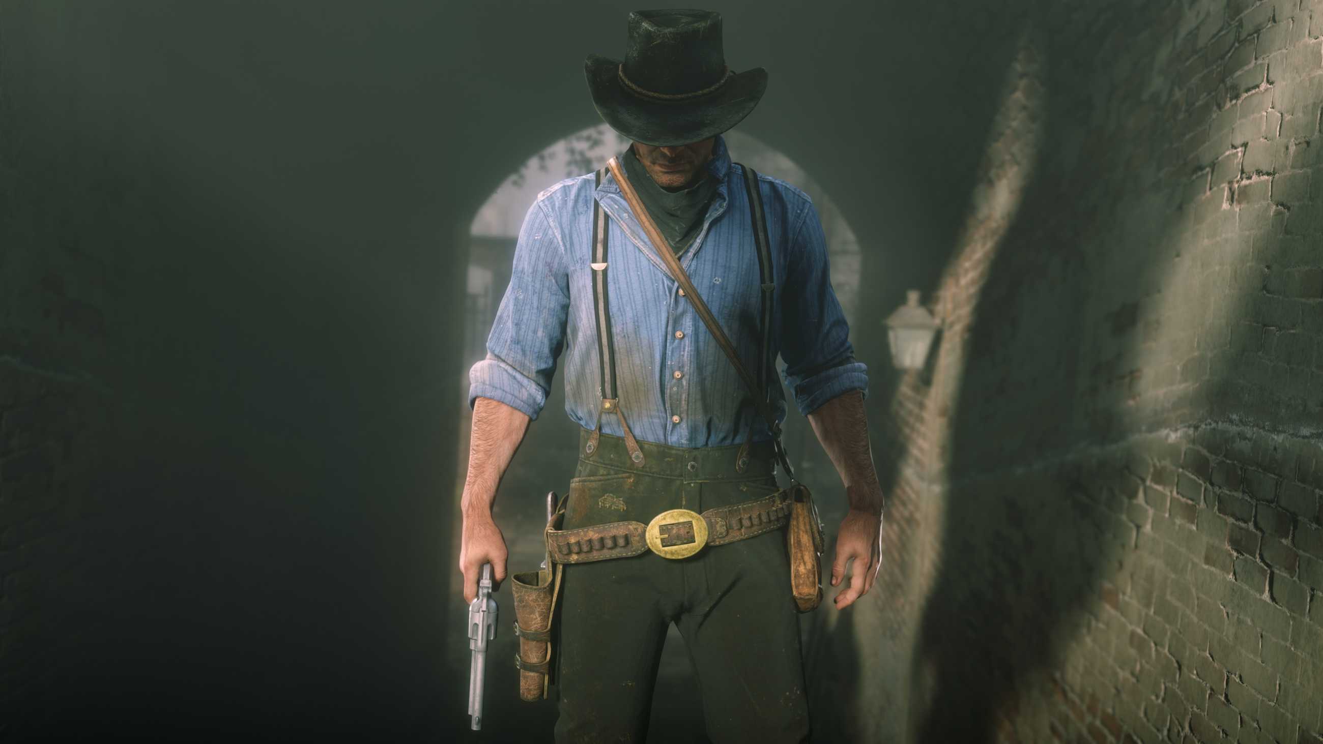 a man wearing a cowboy hat and holding a revolver, Arthur Morgan, looks down while standing on a staircase in Red Dead Redemption 2