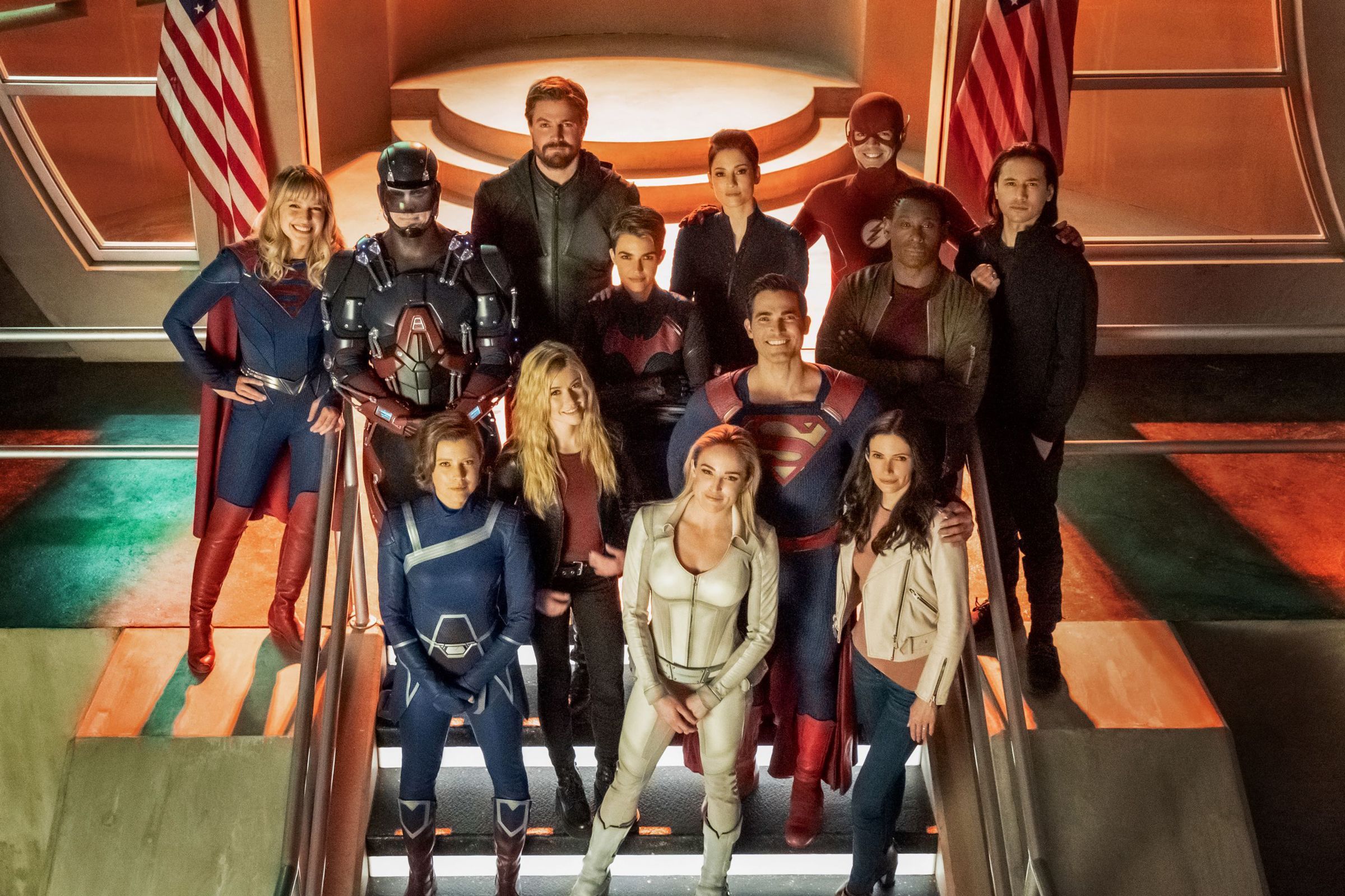 The cast of Crisis on Infinite Earths, including Supergirl, the Atom, Green Arrow, the Flash, Superman, and more.