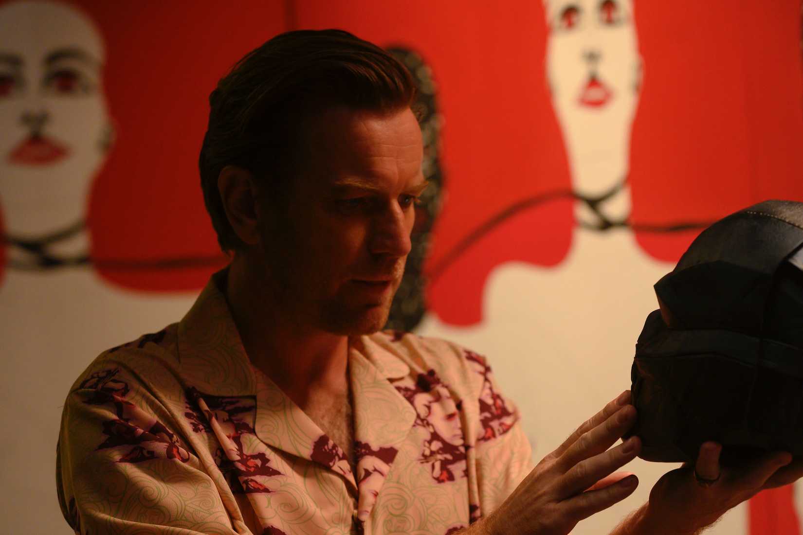 EWAN McGREGOR considers his literal black mask as Roman Sionis in Warner Bros. Pictures’ “BIRDS OF PREY (AND THE FANTABULOUS EMANCIPATION OF ONE HARLEY QUINN).