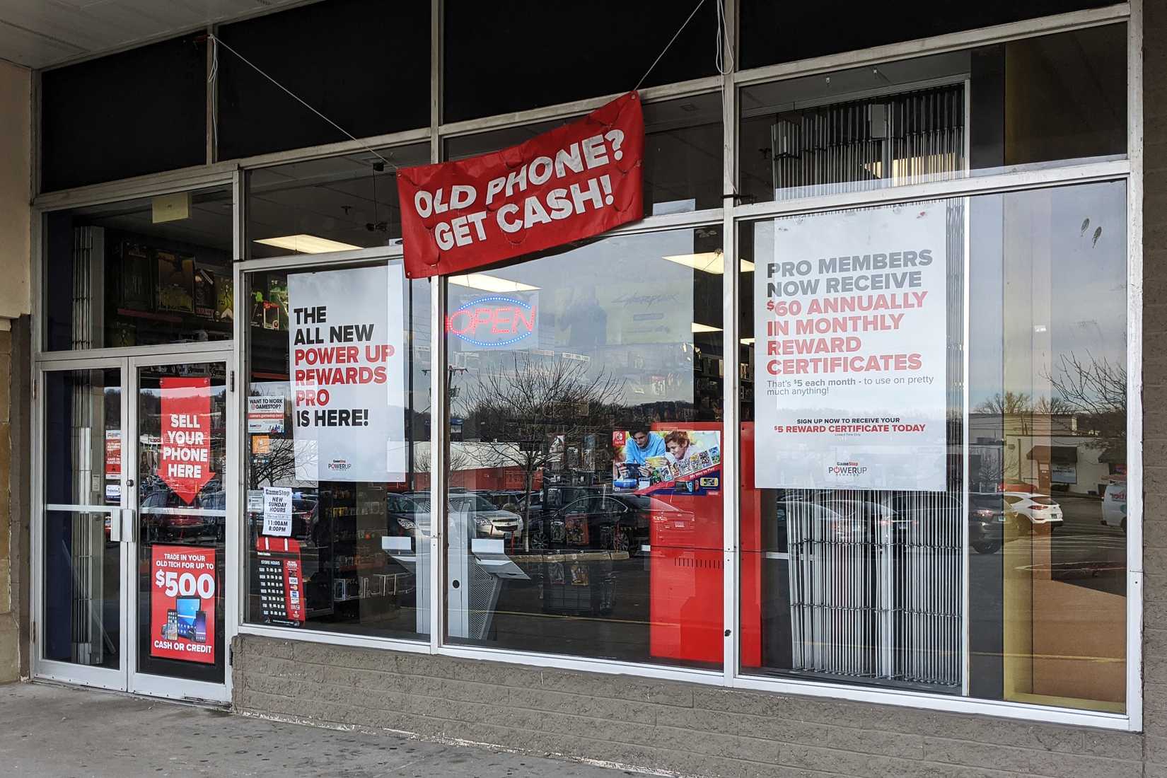 front of GameStop shop featuring numerous promotions