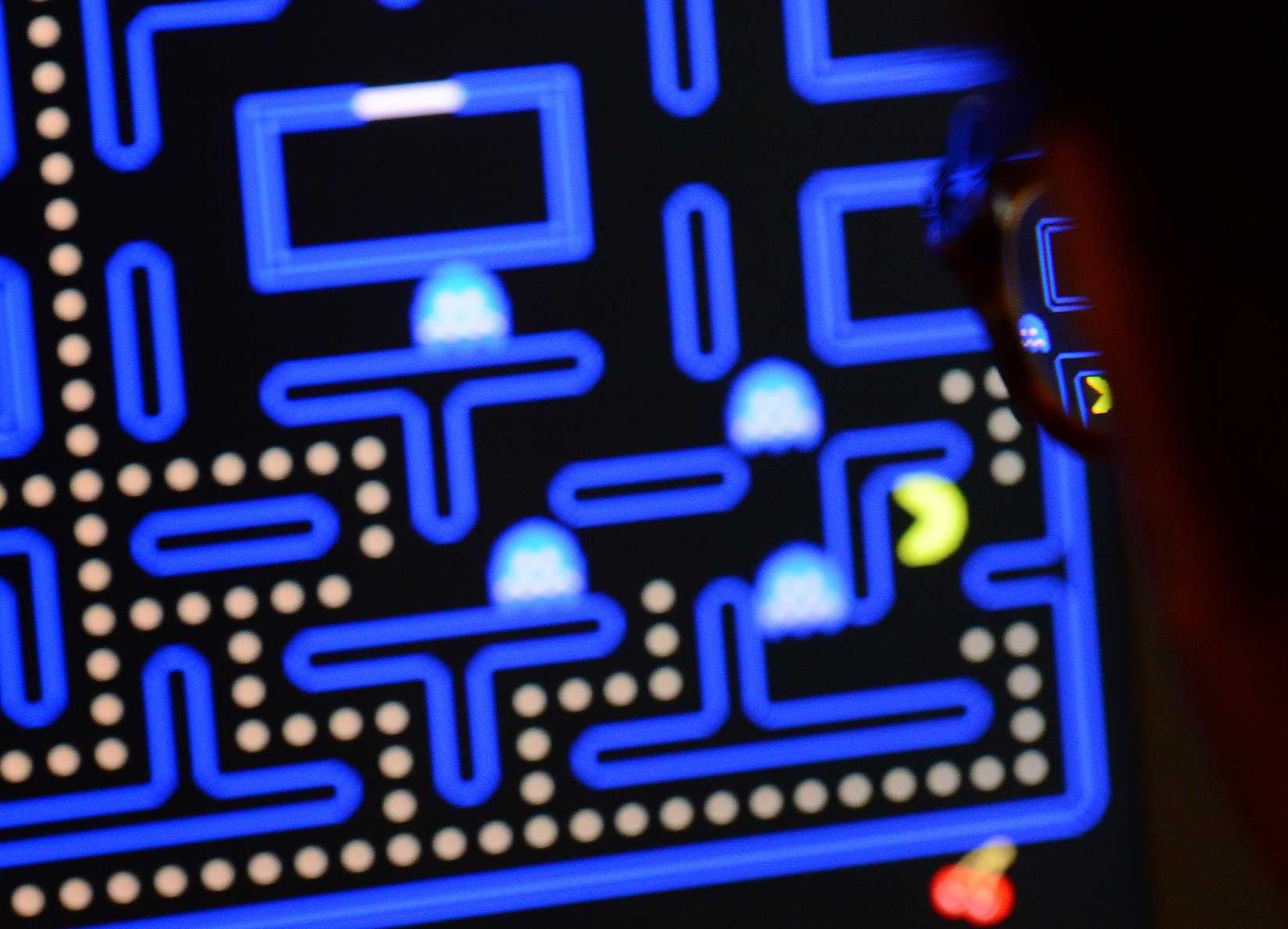a photo of a person playing Pac-Man
