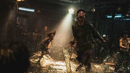 a zombie chases rebels in Train to Busan Presents Peninsula