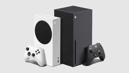 a product render showing an angle view of the Xbox Series S standing vertically with a controller standing against it, to the left of an Xbox Series X standing vertically with a controller standing against it