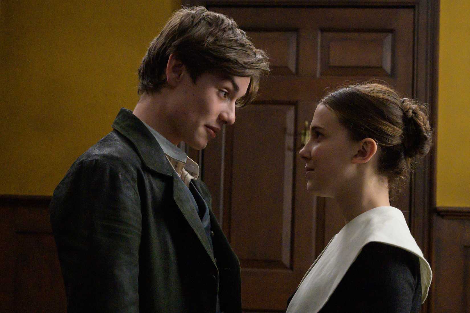 a young man and woman speak to each other