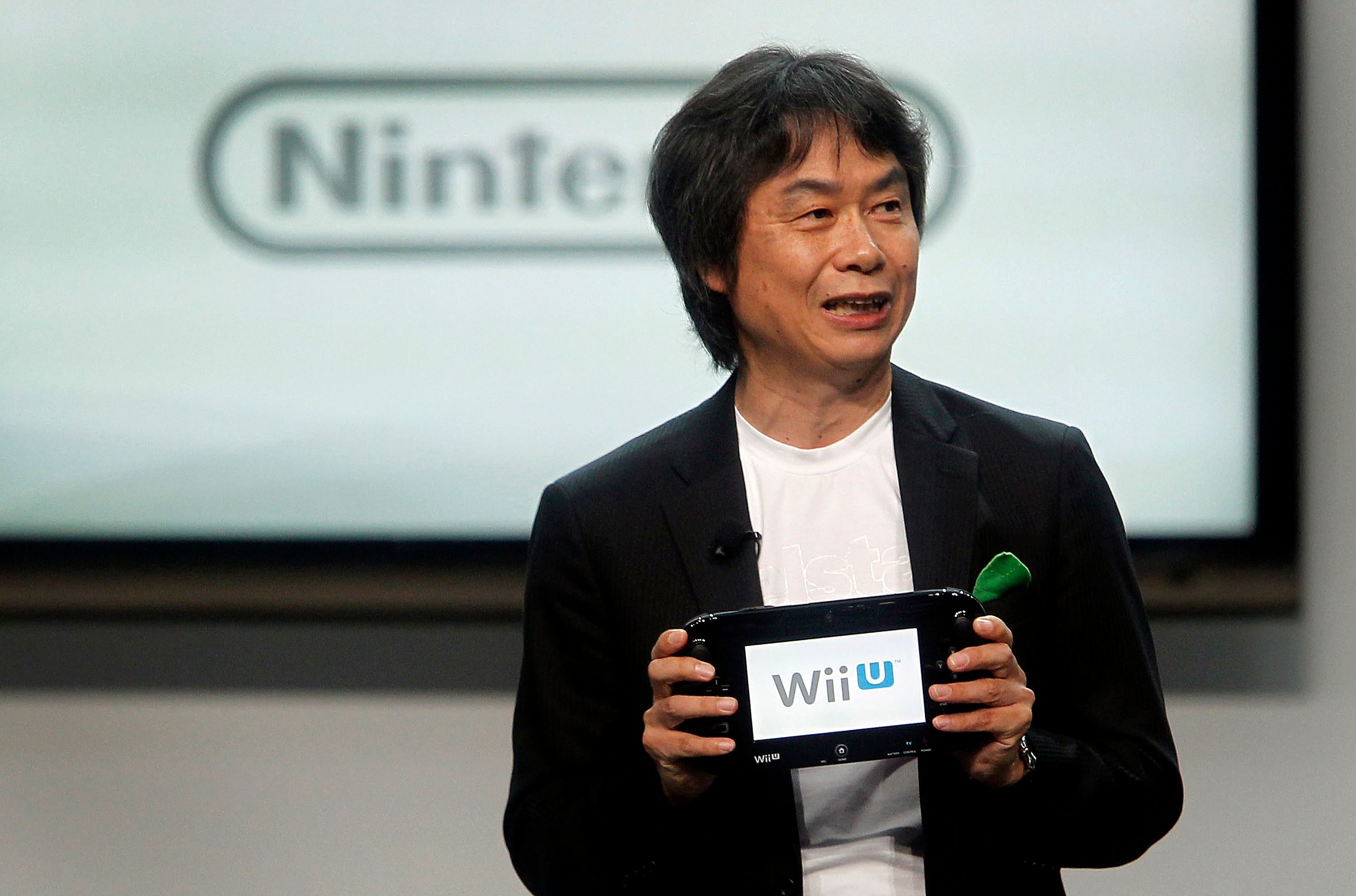 Shigeru Miyamoto speaks at the E3 Expo in Los Angeles in 2012, holding a Wii U GamePad