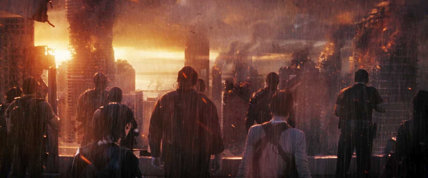 A handful of people, seen from behind, stand in torrential CGI rain and look out at a burning CGI city in The Tomorrow War