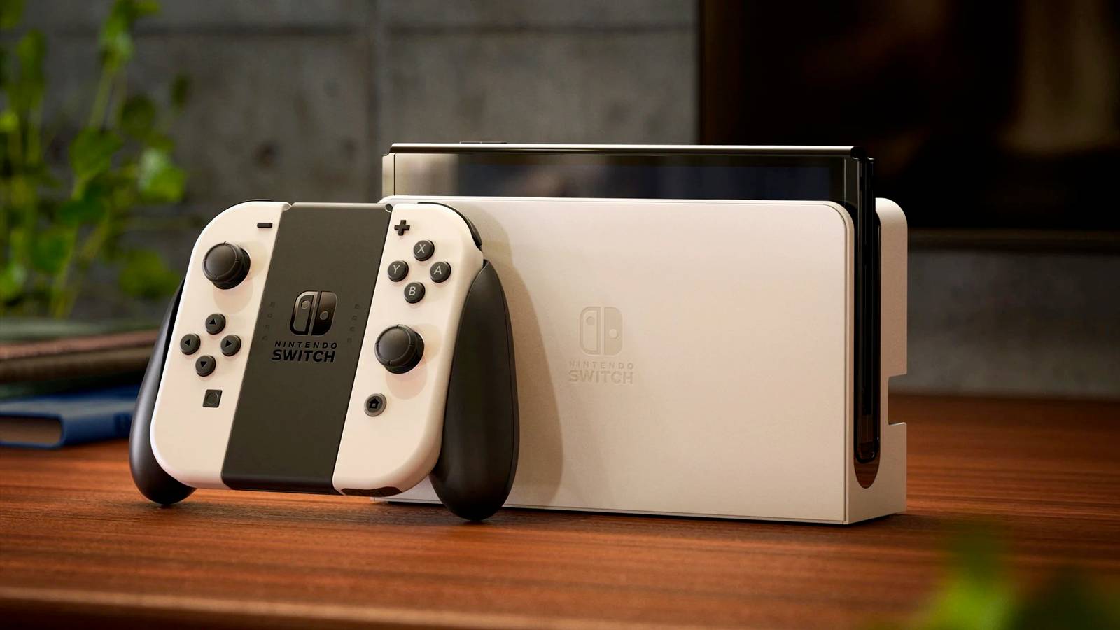 A photo of the Nintendo Switch (OLED model) in white on a wooden table