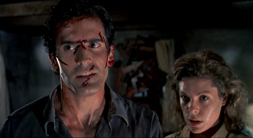Bruce Campbell and Denise Bixler look scared and horrified in Evil Dead 2