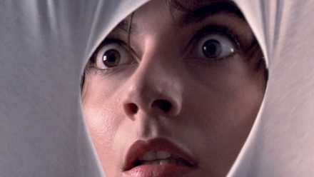 Tenebrae (1982): A woman looks through a white cloth