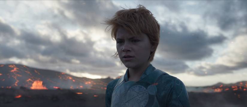 Sprite (Lia McHugh) crying on a volcanic beach in Eternals