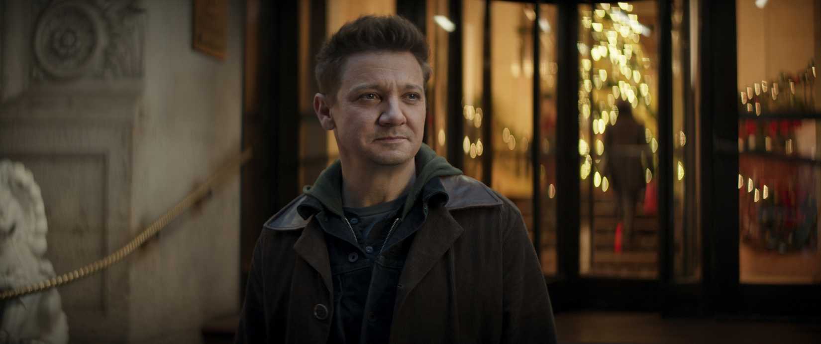 Clint Barton (Jeremy Renner) standing outside an expensive Manhattan hotel in Hawkeye.