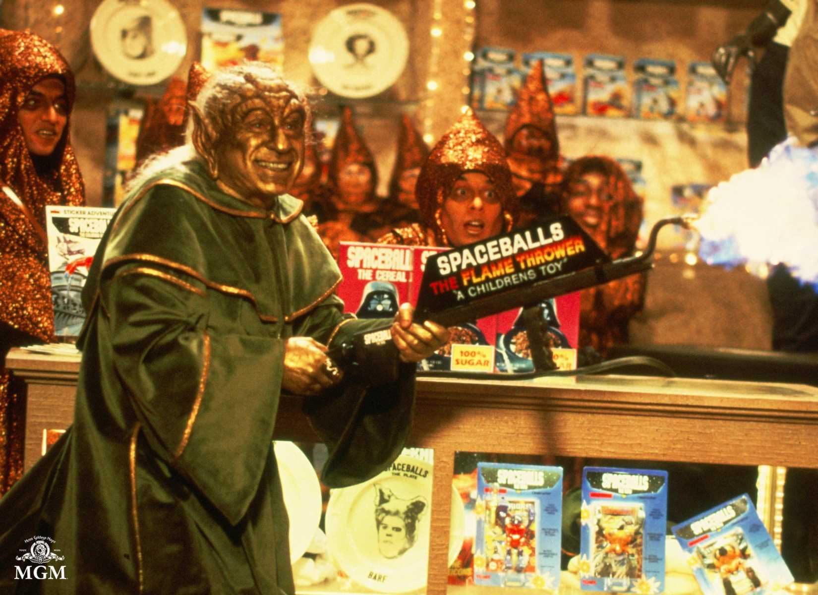 Mel Brooks as Yoda parody Yogurt in Spaceballs, hawking merchandise.