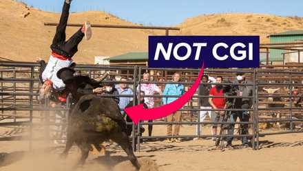a man being thrown in the air by a bull with a graphic arrow pointing at the bull and the words “NOT CGI” in a box by the arrow
