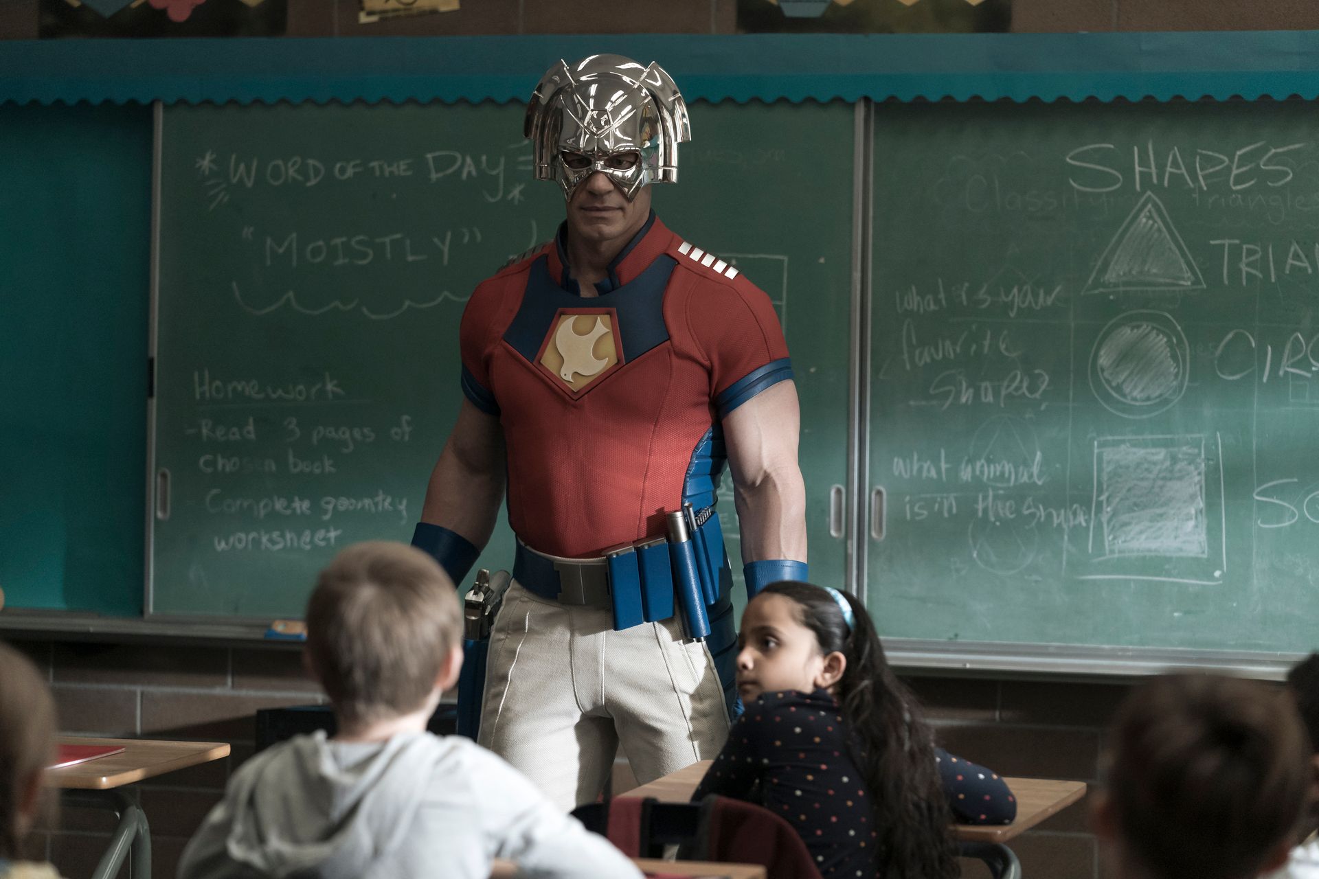 Peacemaker talking to a classroom of children