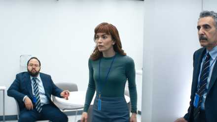 Three members of the Severance innie gang in the office looking kind of surprised at something off-camera