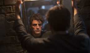 Steven Grant/Marc Spector stares into a mirror, disillusioned in the Disney Plus series Moon Knight