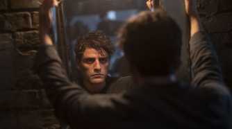 Steven Grant/Marc Spector stares into a mirror, disillusioned in the Disney Plus series Moon Knight