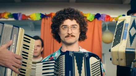 Daniel Radcliffe as Weird Al Yankovic, flanked by accordions, in a still from Weird: The Al Yankovic Story